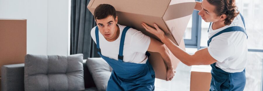 heavy-boxes-two-young-movers-blue-uniform-working-indoors-room-min Home Moving Service