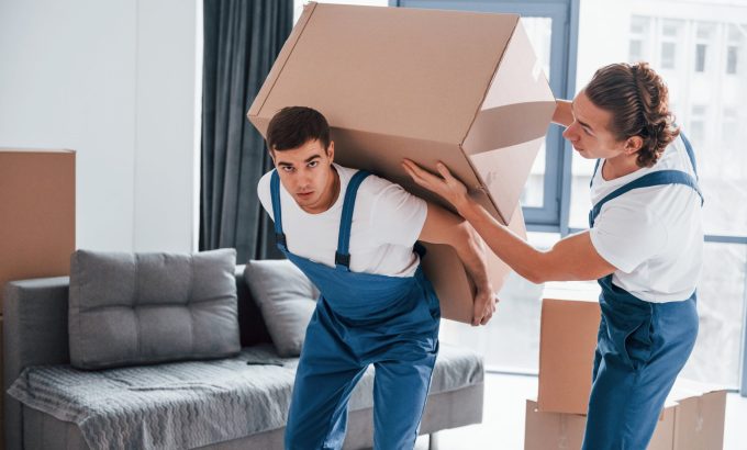 heavy-boxes-two-young-movers-blue-uniform-working-indoors-room-min Home Moving Service