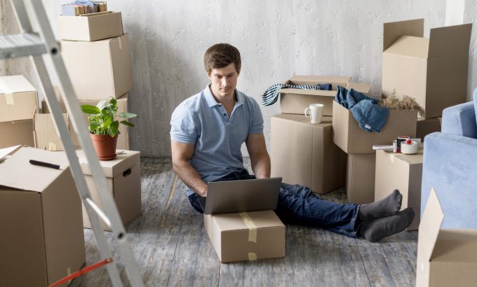 geotagged-man-working-laptop-with-boxes-ready-move-out Home Move in Arlington TX